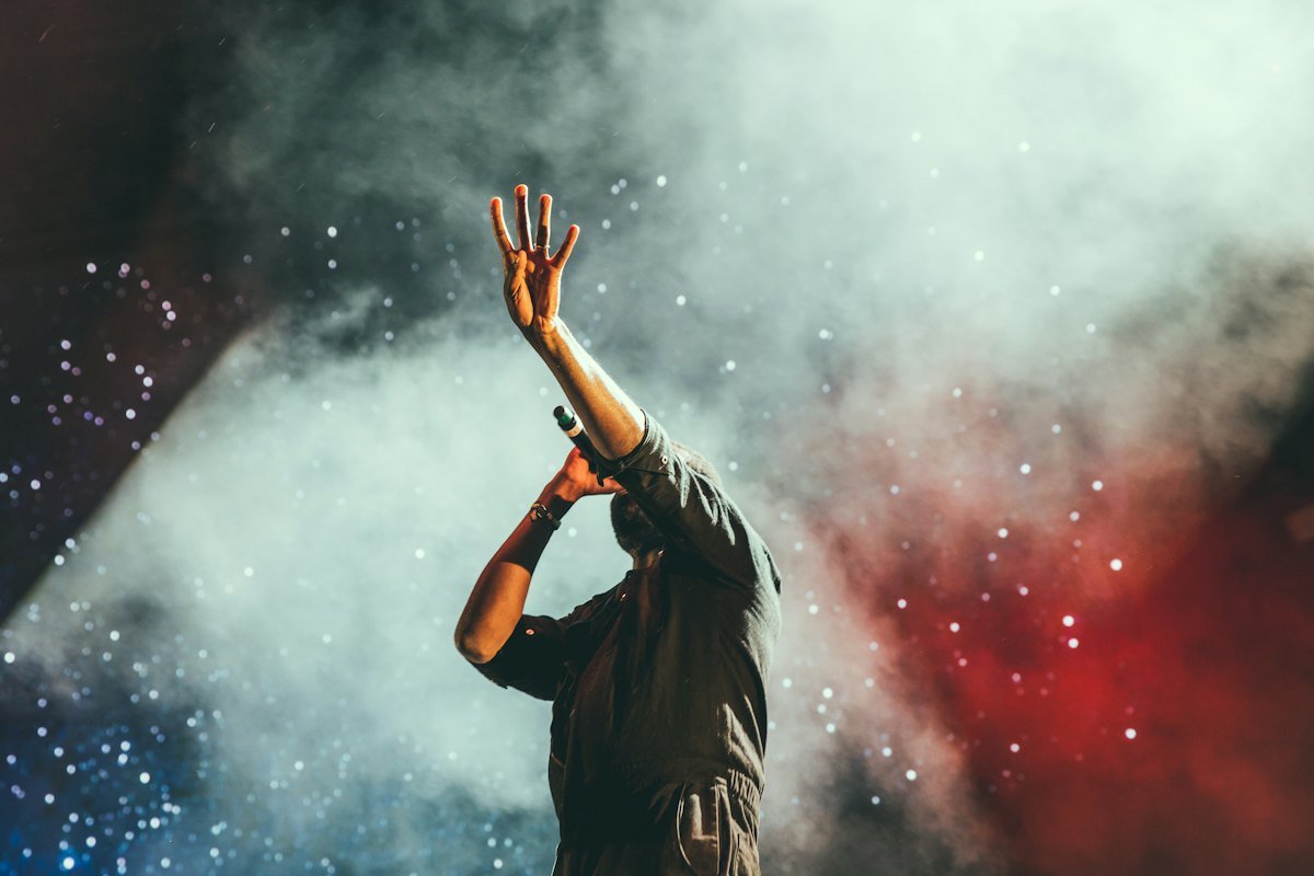 Musician performing on stage with a microphone